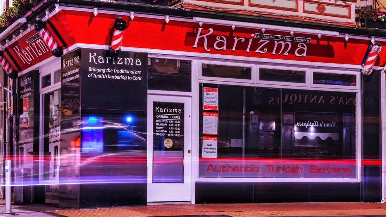 Karizma Turkish Barbers shopfront at 58 Oliver Plunkett Street, Cork, at night